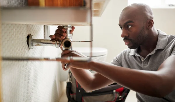 a male plumber fixing a pipe connection from Emergency Plumber San Marcos in San Marcos, TX a male plumber fixing a pipe connection from Emergency Plumber San Marcos in San Marcos, TX